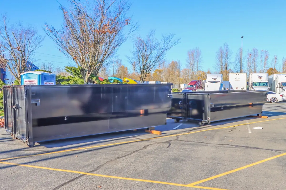 Professional dumpster rental service with roll-off container on residential driveway in Bridgeport